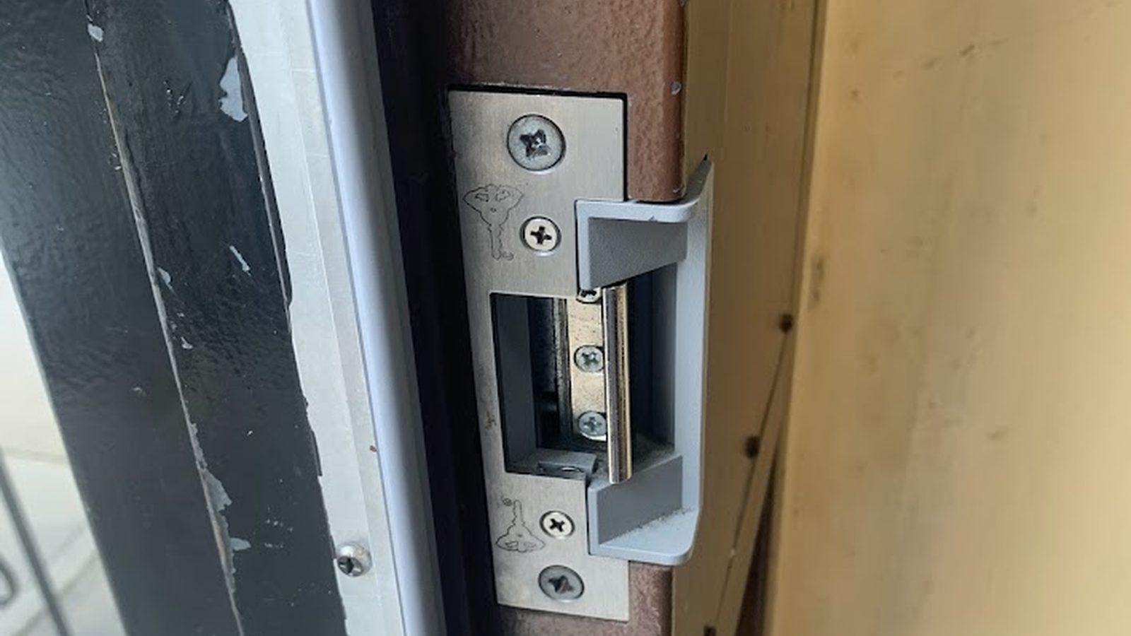 Electric door strike installed in an apartment building entrance frame